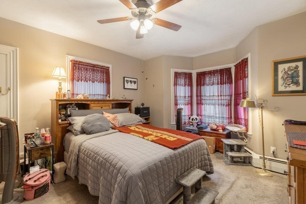 20 Washington Street Danvers, MA 01923 - Photo 15 of 39 a bedroom with a bed and a chandelier