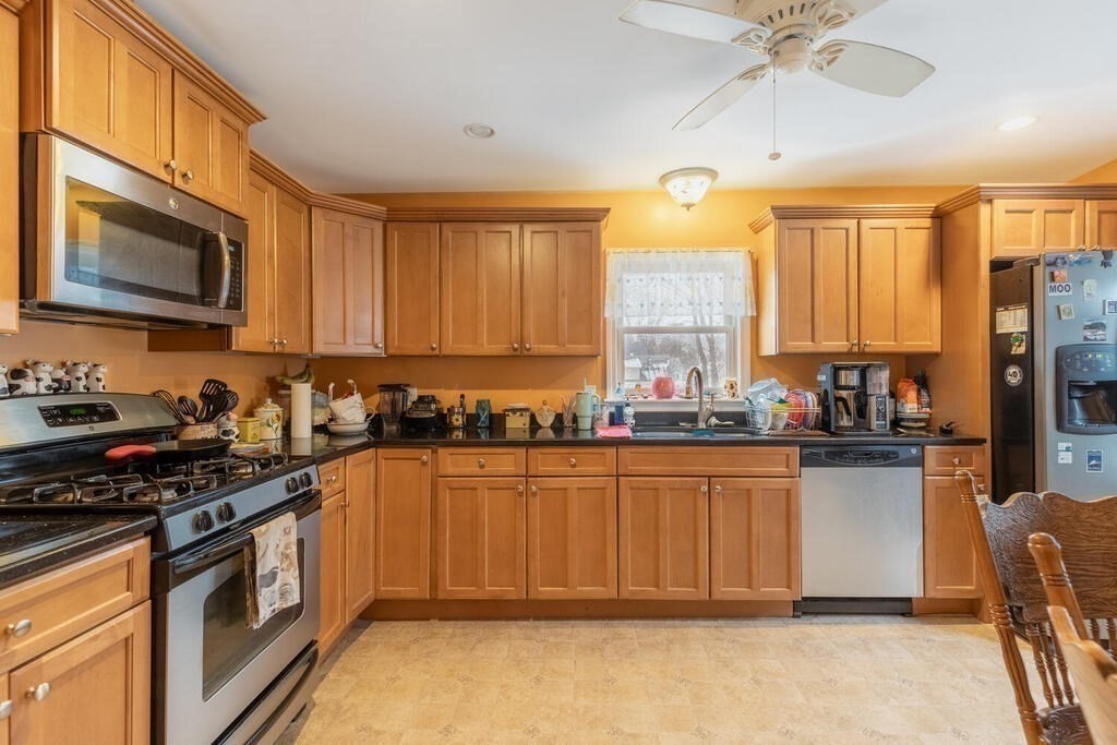 20 Washington Street Danvers, MA 01923 - Photo 19 of 39 a kitchen with stainless steel appliances granite countertop a stove sink and cabinets