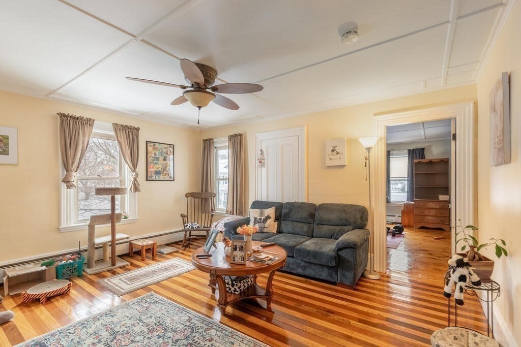 20 Washington Street Danvers, MA 01923 - Photo 21 of 39 a living room with furniture a wooden floor and a table