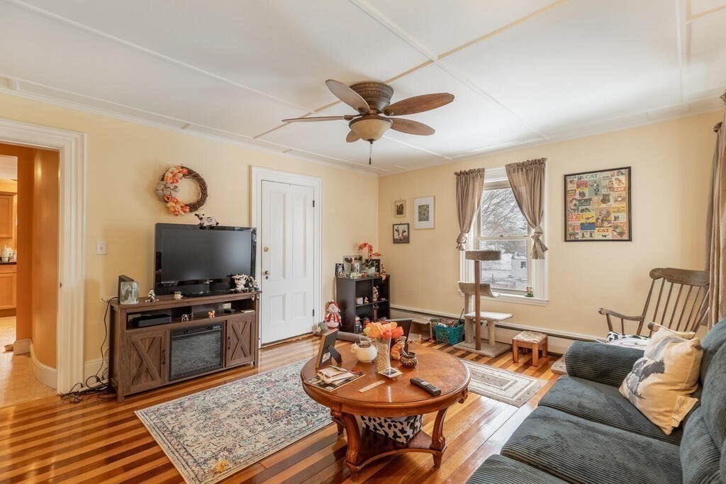 20 Washington Street Danvers, MA 01923 - Photo 22 of 39 a living room with furniture a rug and a flat screen tv