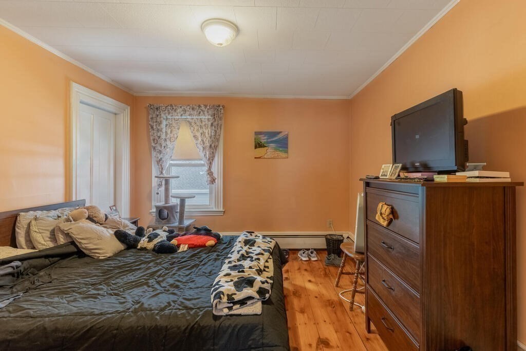 20 Washington Street Danvers, MA 01923 - Photo 25 of 39 a bedroom with a bed and flat screen tv