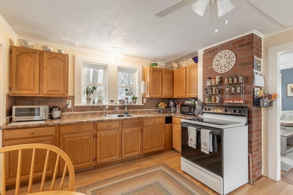 20 Washington Street Danvers, MA 01923 - Photo 28 of 39 a kitchen with stainless steel appliances granite countertop a stove and a sink