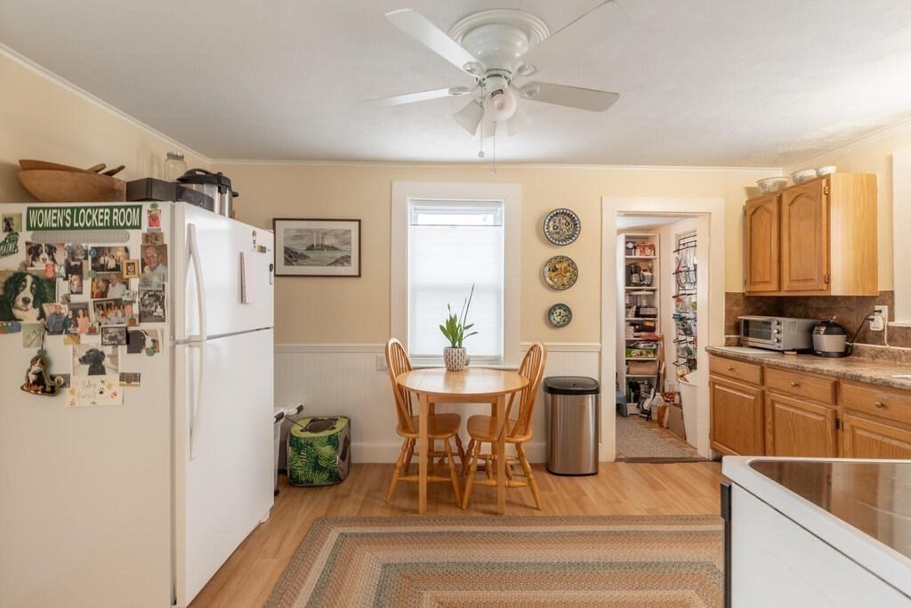 20 Washington Street Danvers, MA 01923 - Photo 30 of 39 a dining room with stainless steel appliances kitchen island granite countertop furniture and a chandelier