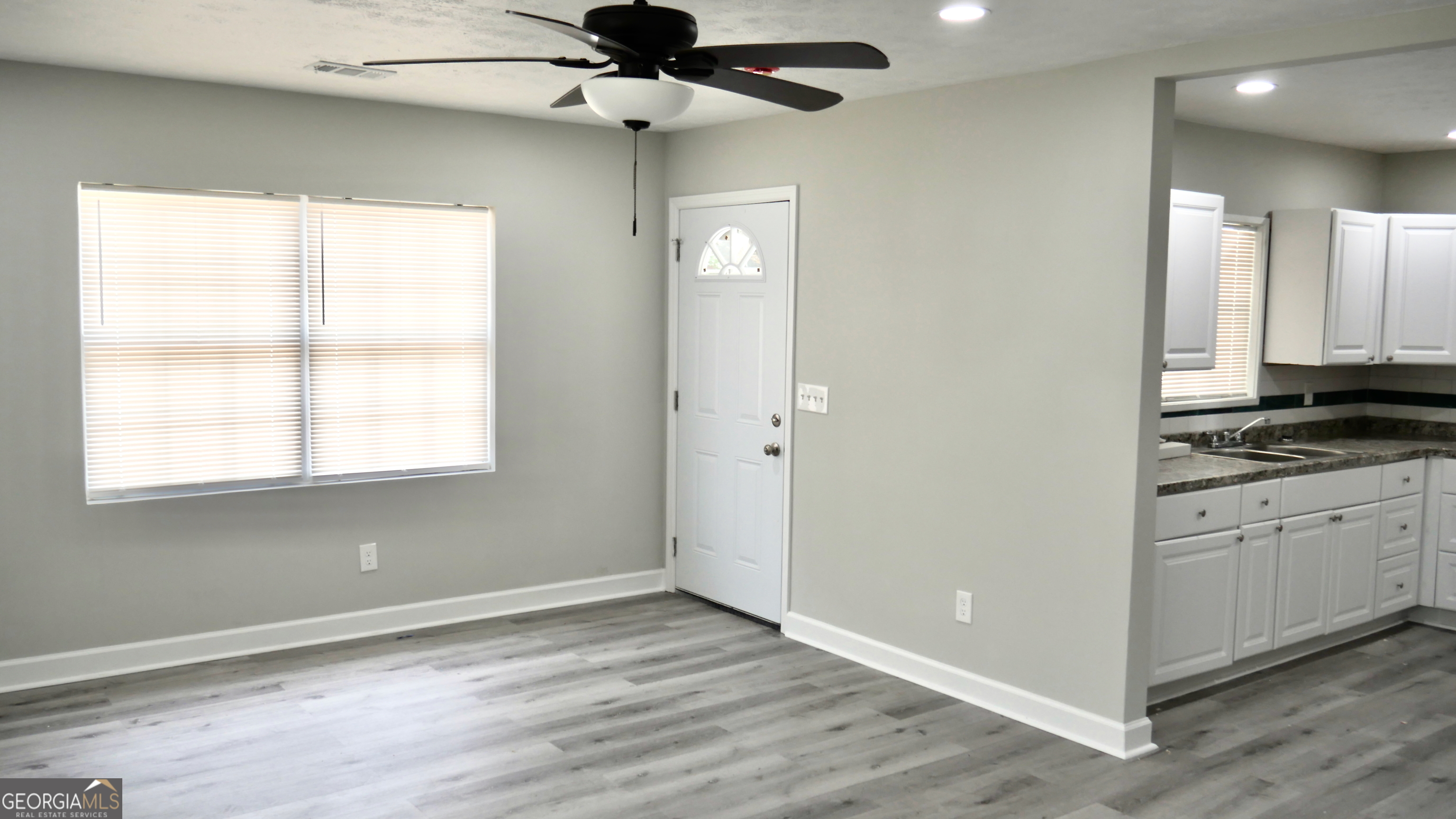 2830 North Lumpkin Road Columbus, GA 31903 - Photo 11 of 12 a view of an empty room with window and wooden floor