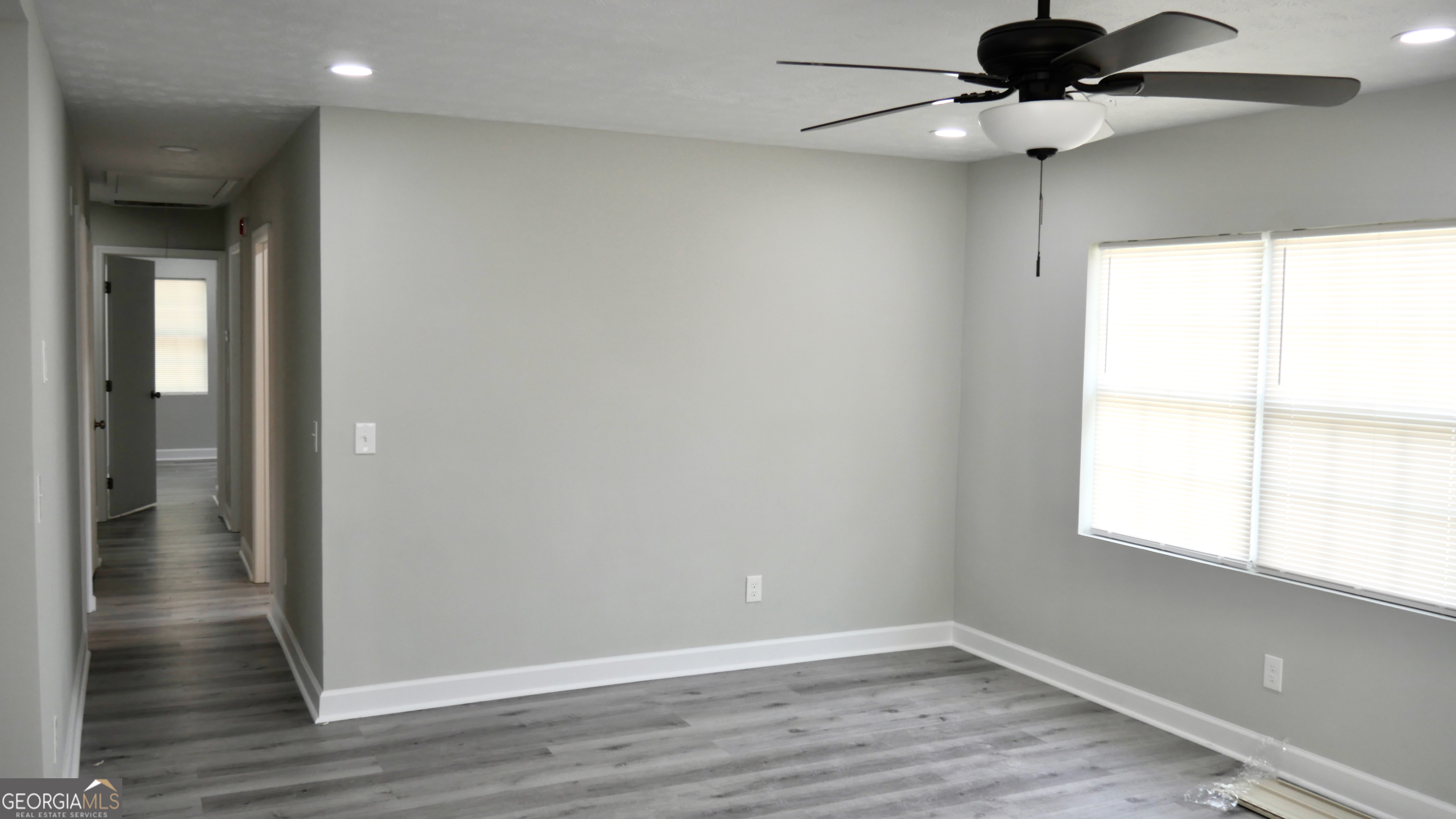 2830 North Lumpkin Road Columbus, GA 31903 - Photo 12 of 12 a view of an empty room with wooden floor and a window
