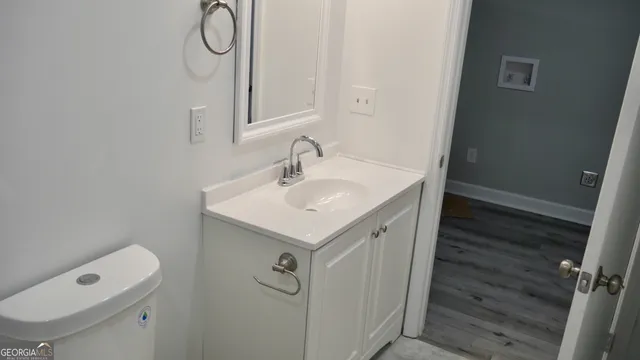 a bathroom with a sink vanity and a toilet