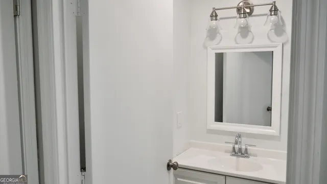 a bathroom with a sink a mirror and vanity