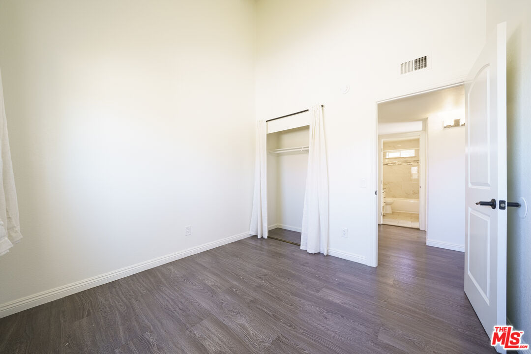 43609 Stanridge Avenue Lancaster, CA 93535 - Photo 12 of 25 a view of an empty room with wooden floor