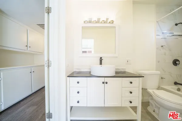 a bathroom with a sink a toilet and vanity