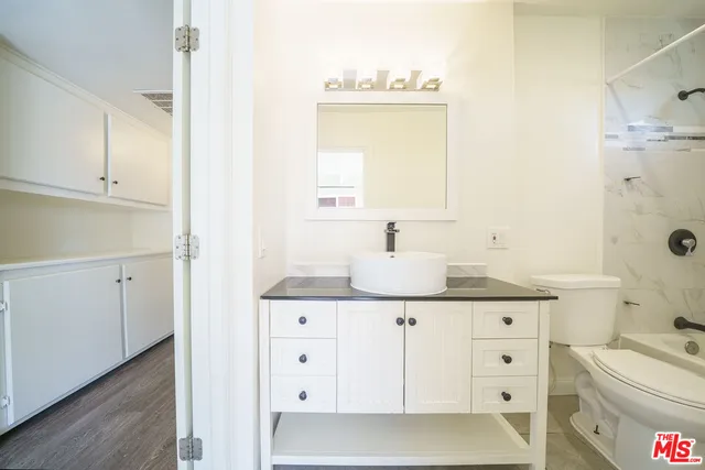 a bathroom with a sink a toilet and vanity