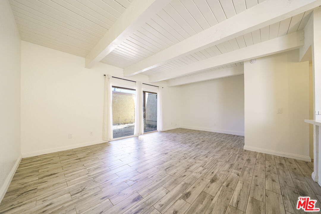 43609 Stanridge Avenue Lancaster, CA 93535 - Photo 3 of 25 a view of an empty room and wooden floor