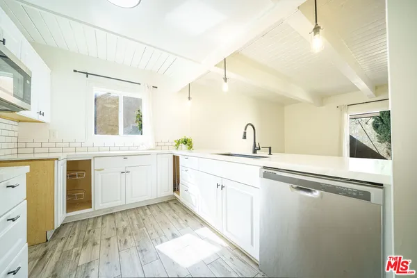 a spacious bathroom with a granite countertop sink and a mirror