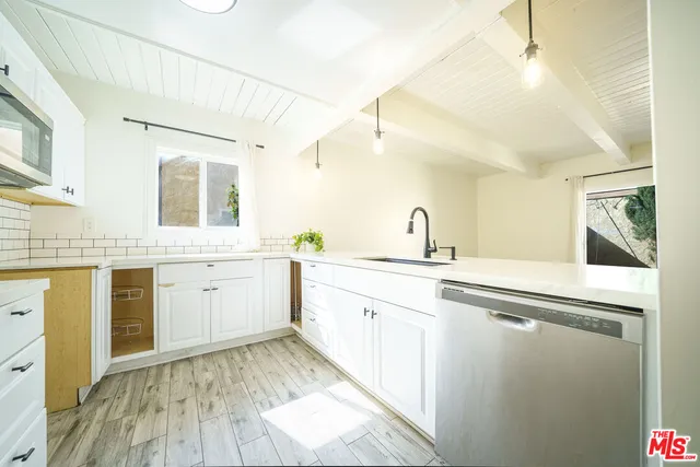 a spacious bathroom with a granite countertop sink and a mirror