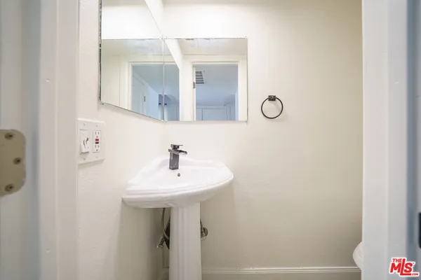 a bathroom with a sink a mirror and vanity