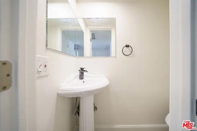 a bathroom with a sink a mirror and vanity