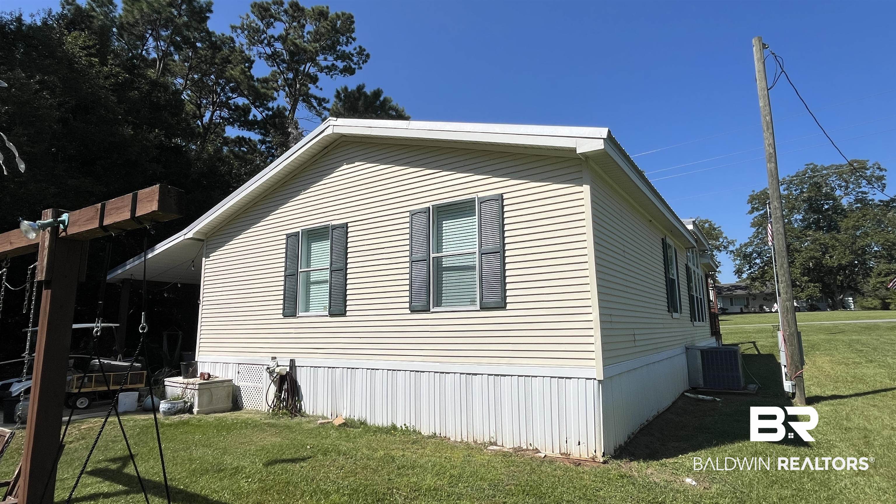 12932 Santa Piedro Street Lillian, AL 36549 - Photo 17 of 20 View of home's exterior featuring a lawn and a cooling unit