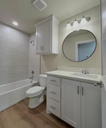 an empty room with closet and a chandelier fan