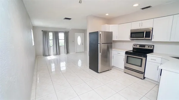 a kitchen with stainless steel appliances a refrigerator stove and microwave
