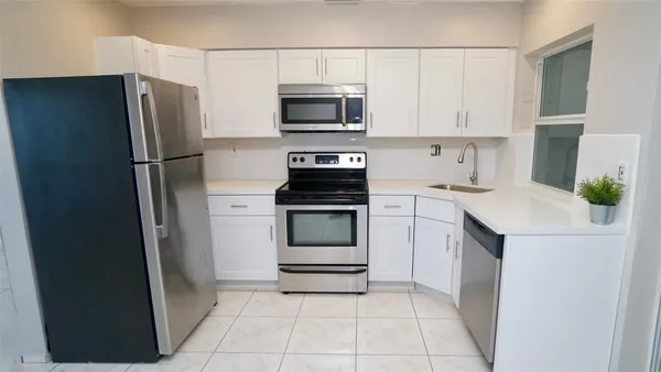 a kitchen with a refrigerator stove and microwave