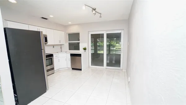 a kitchen with stainless steel appliances a refrigerator and a sink