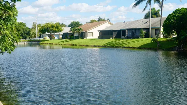 a view of a house with a yard and swimming pool