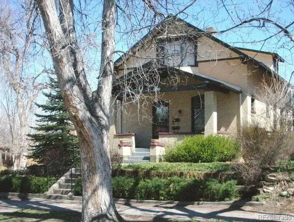 a front view of a house with trees