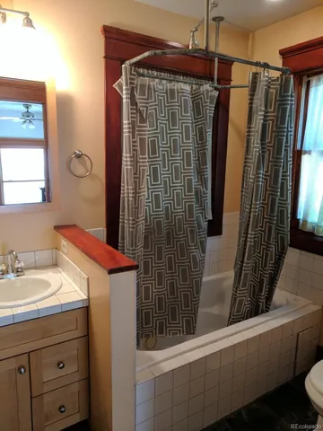 a bathroom with a shower and a sink