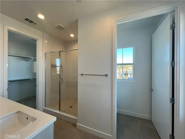 a bathroom with a tub a sink and shower