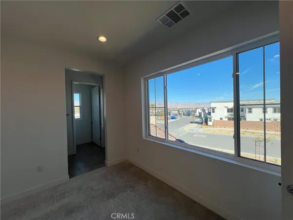 a room with a window and a ceiling fan