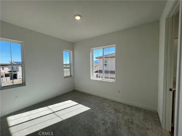 an empty room with a empty space and windows