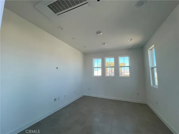 wooden floor in an empty room with windows and closet