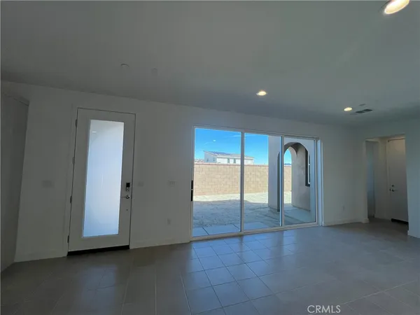 an empty room with glass door and windows