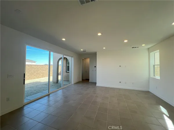 an empty room with sliding glass door and shower