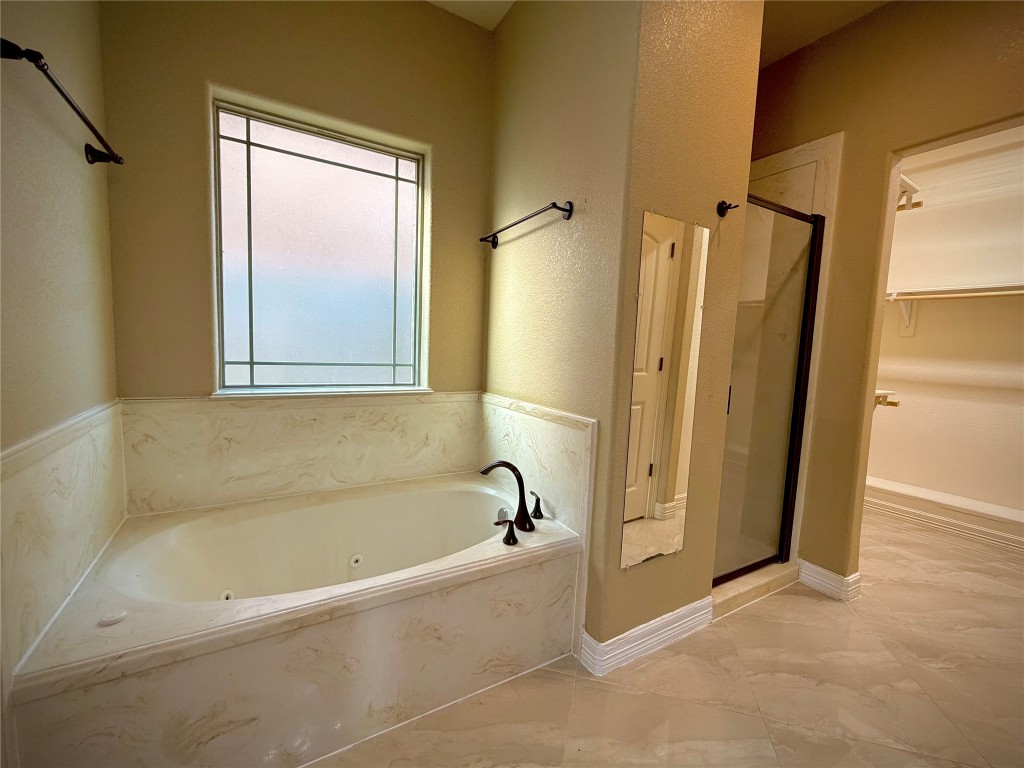 3741 Debbie Lane Groves, TX 77619 - Photo 9 of 16 a bathroom with a bathtub and a shower