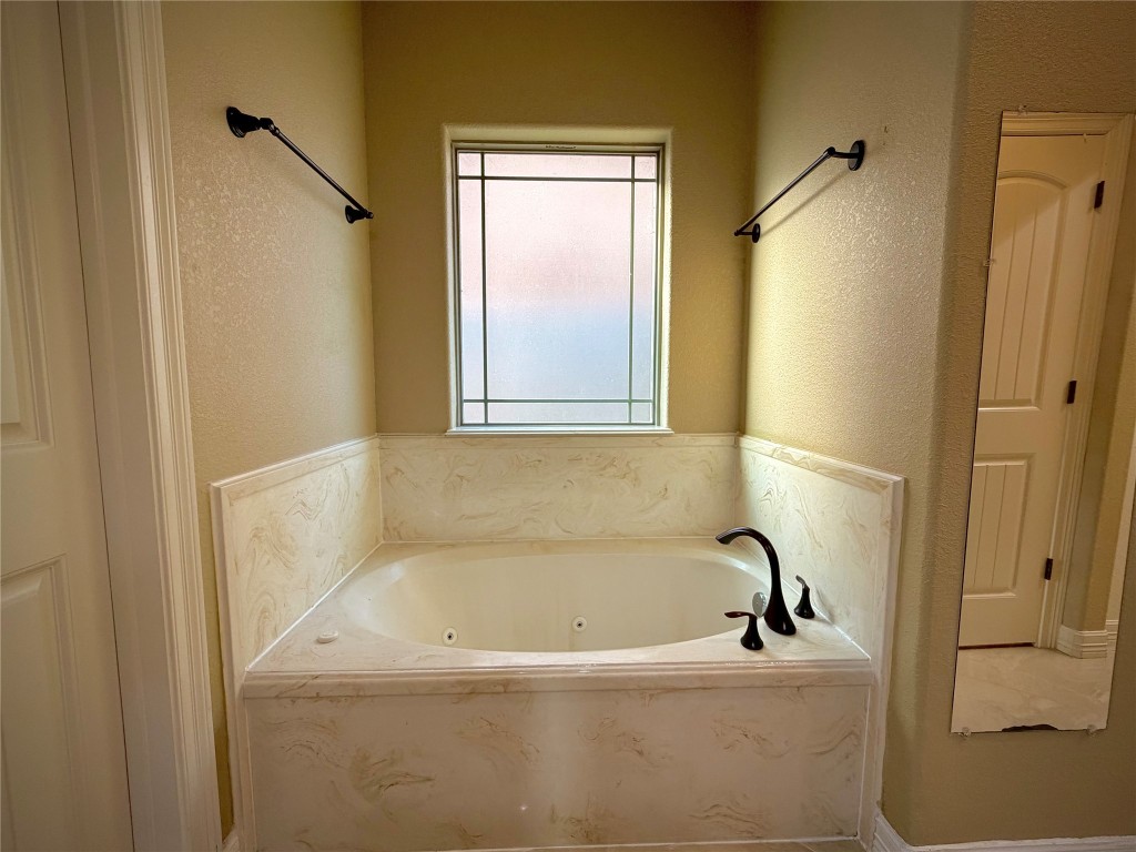 3741 Debbie Lane Groves, TX 77619 - Photo 10 of 16 a white bath tub sitting next to a window