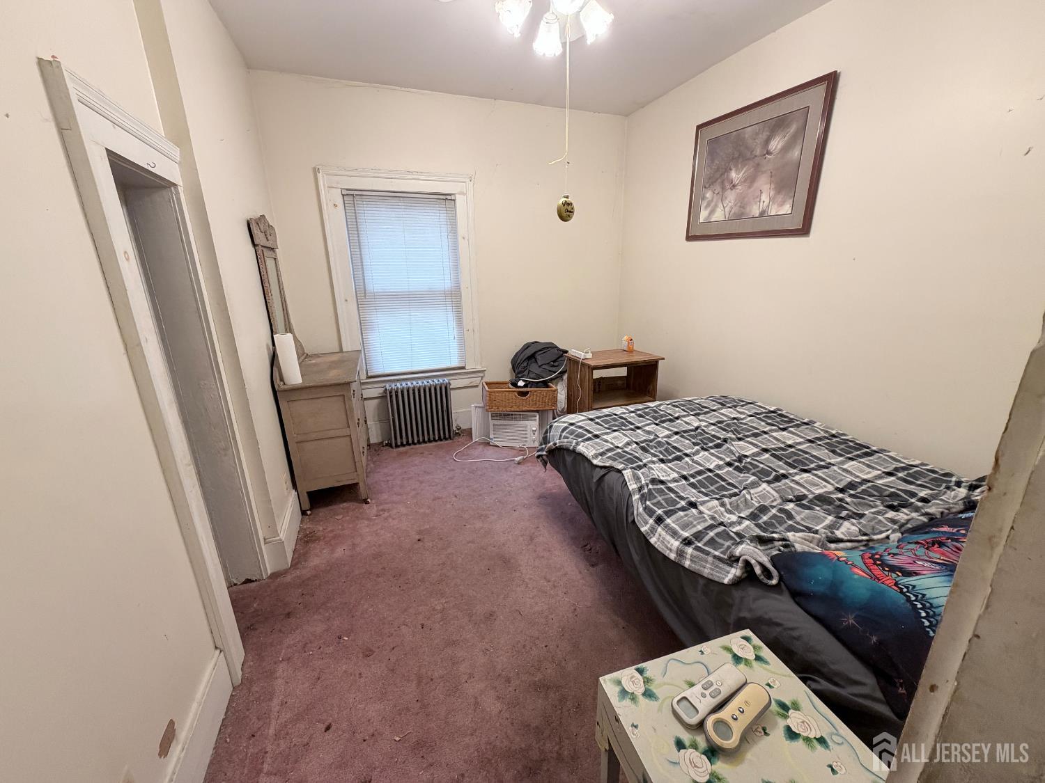 41 Atlantic Street Keyport, NJ 07735 - Photo 16 of 48 a bedroom with a bed and a dresser in it