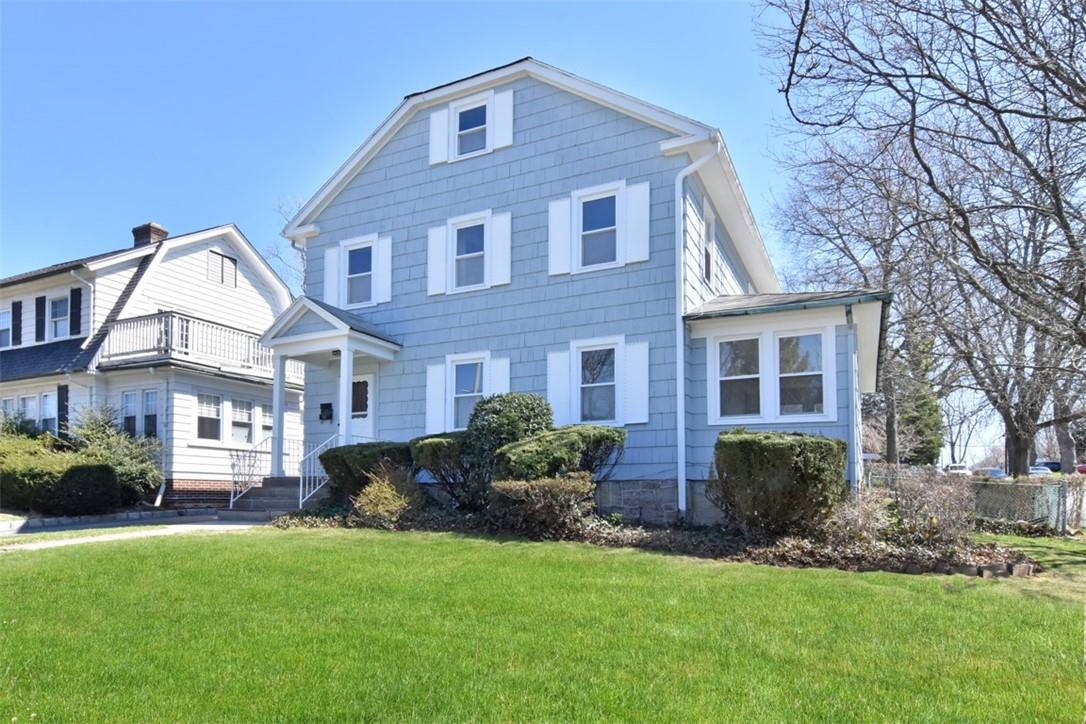 a front view of a house with a garden