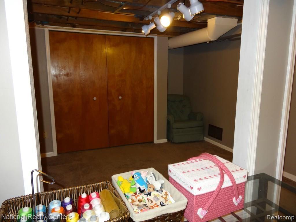16678 Rougeway Street Livonia, MI 48154 - Photo 26 of 38 Basement sitting room and closet storage.