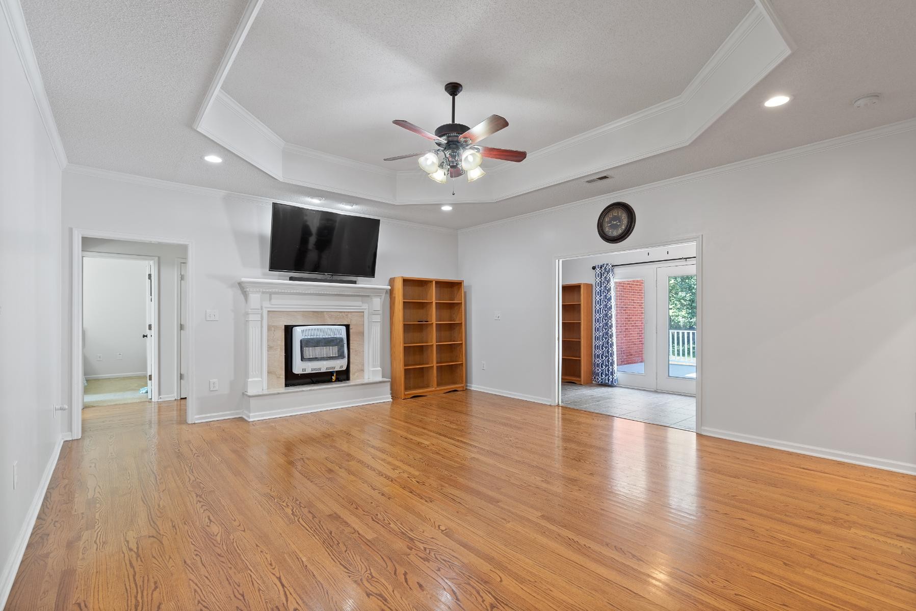 28 Spring Valley Road Taft, TN 38488 - Photo 12 of 55 a view of a livingroom with a fireplace a ceiling fan and brick wall