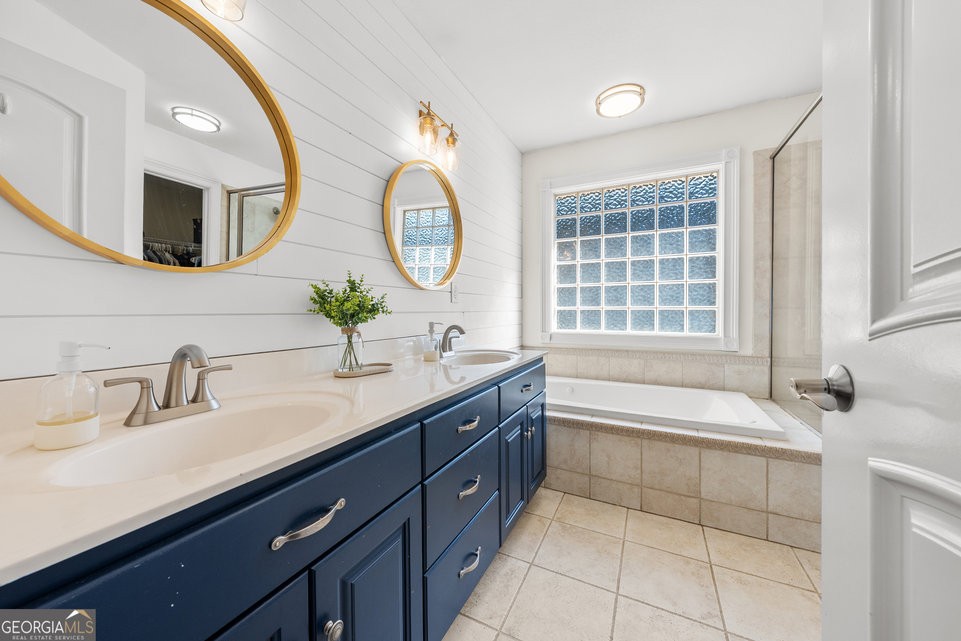 175 Highland Ridge Drive Hartwell, GA 30643 - Photo 22 of 46 a bathroom with a granite countertop sink a large mirror and bathtub