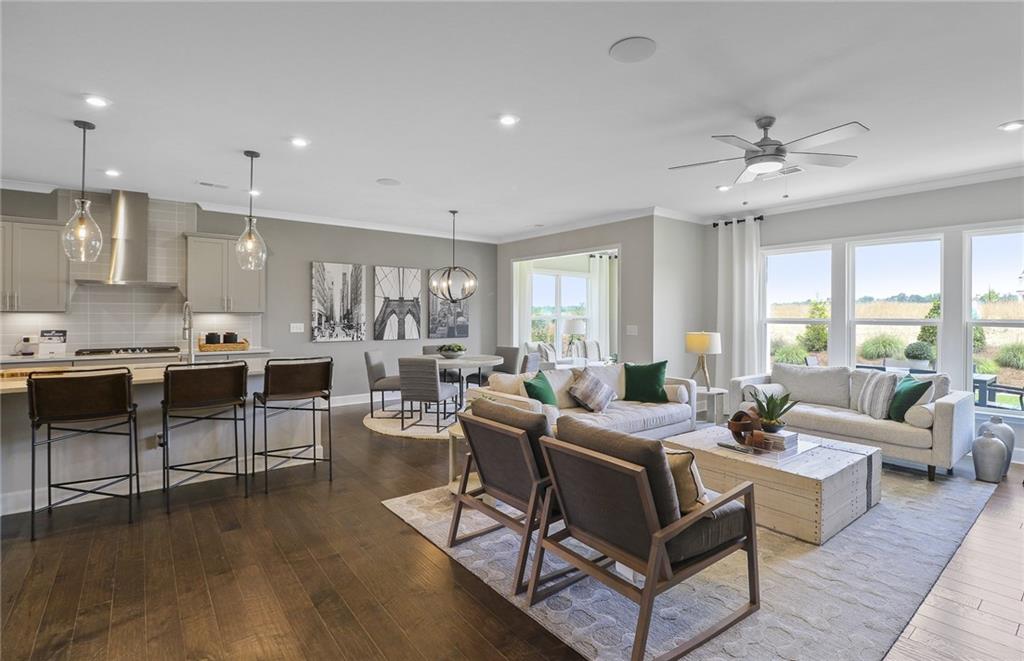 4397 Azalea Ridge Way Hoschton, GA 30548 - Photo 14 of 41 a living room with furniture kitchen view and a large window
