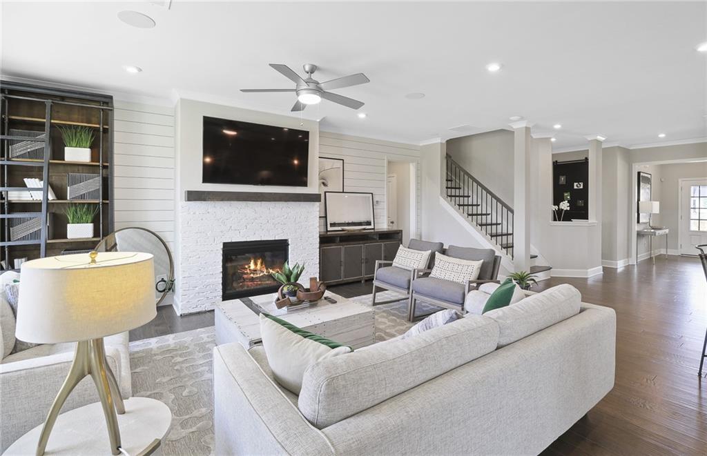 4397 Azalea Ridge Way Hoschton, GA 30548 - Photo 16 of 41 a living room with furniture a flat screen tv and a fireplace