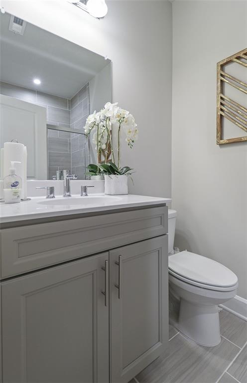 4397 Azalea Ridge Way Hoschton, GA 30548 - Photo 19 of 41 a bathroom with a toilet sink and mirror