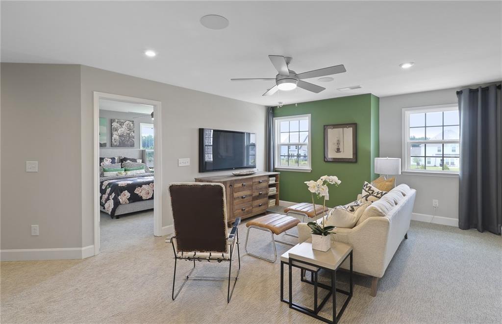 4397 Azalea Ridge Way Hoschton, GA 30548 - Photo 20 of 41 a living room with furniture ceiling fan and a window