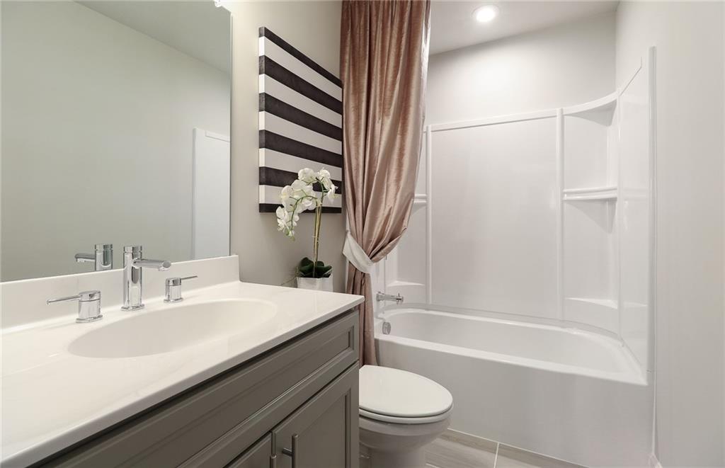 4397 Azalea Ridge Way Hoschton, GA 30548 - Photo 25 of 41 a bathroom with a sink a toilet and a bathtub