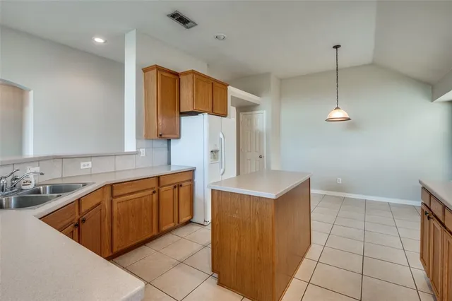 a kitchen with stainless steel appliances granite countertop a sink counter space cabinets and a window