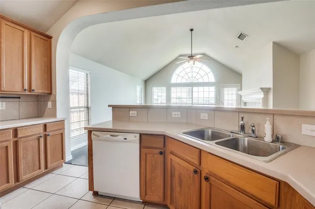 a kitchen with a sink cabinets and window