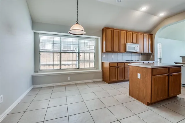 a kitchen with stainless steel appliances granite countertop a sink counter space cabinets and a window