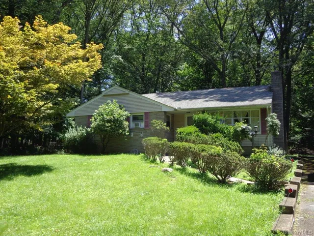 a view of a house with a yard and garden
