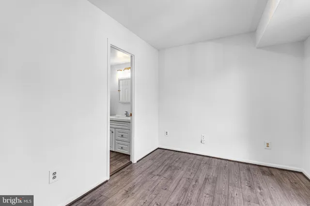 a view of an empty room and wooden floor